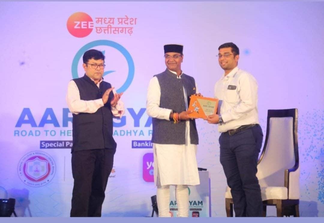 Dr. Sumit Bhatnagar receiving an award on stage